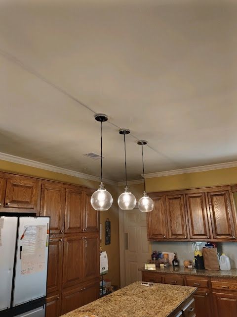 Finished kitchen lighting installed by Cox Electric in a residential interior.