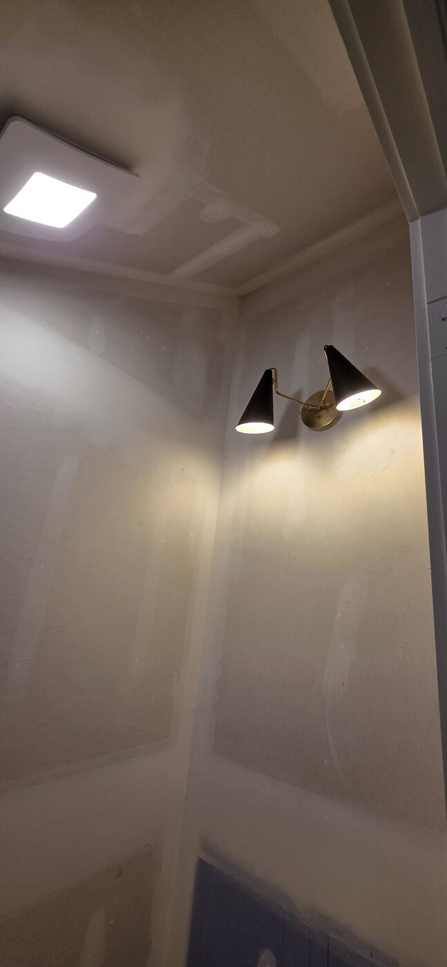 Dual cone wall sconces installed during a residential interior finish-out.
