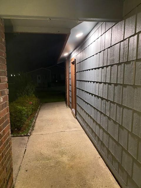 Exterior access and egress lighting installed by Cox Electric along a nighttime walkway.
