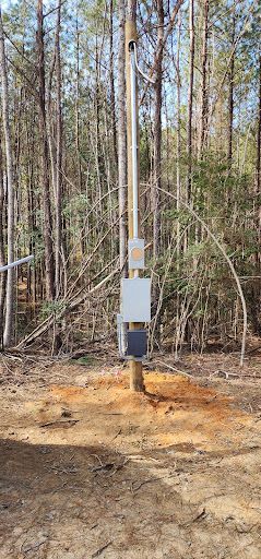 Electrical power pole installation for a property service.